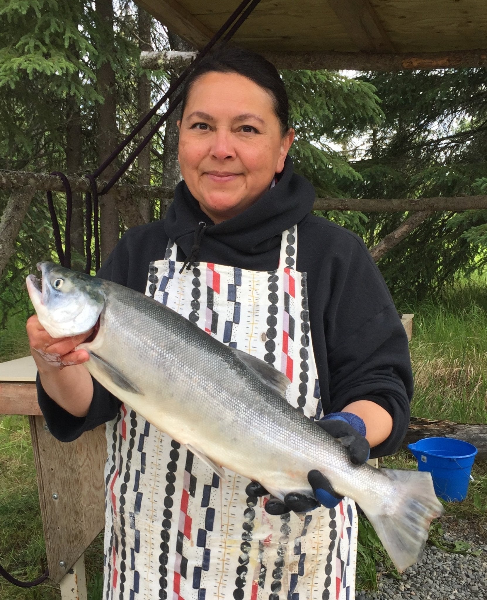 Artist Sonya Kelliher-Combs holding a salmon in Alaska