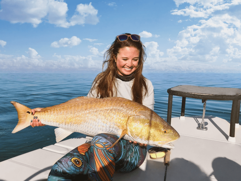 Angler fly fishing from a skiff during a saltwater trip