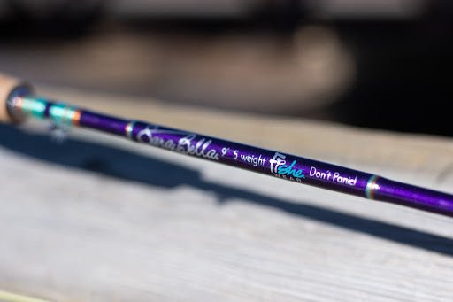 Ryan Scavo holding a custom Fishe and SaraBella fly rod outdoors