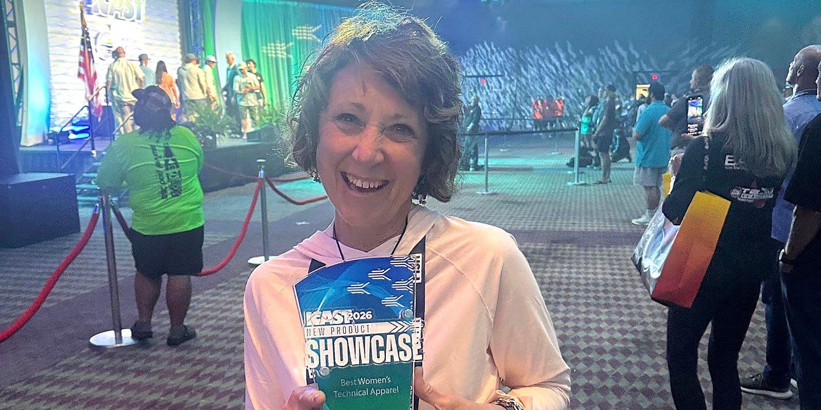 Linda Leary holding FisheWear's ICAST 2026 Best Women's Technical Apparel award in Orlando
