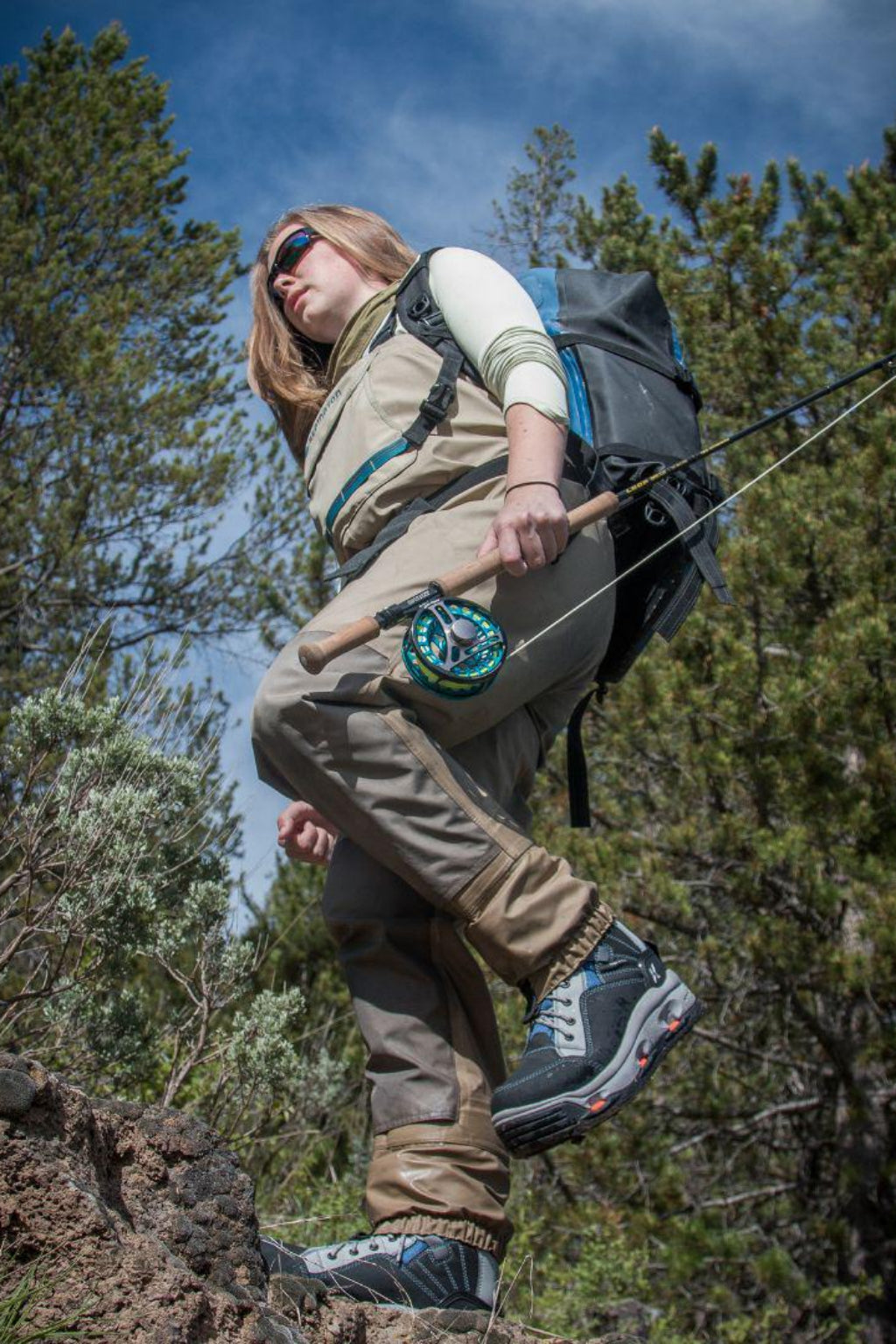 Person hiking with a backpack and bow in a forested area