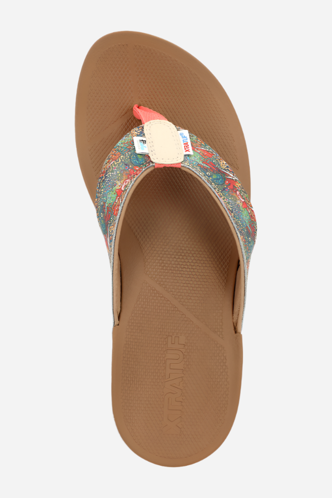 Brown sandal with floral strap on a white background