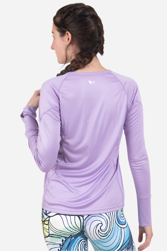 Person wearing a purple long-sleeve athletic shirt with a visible brand logo on a white background