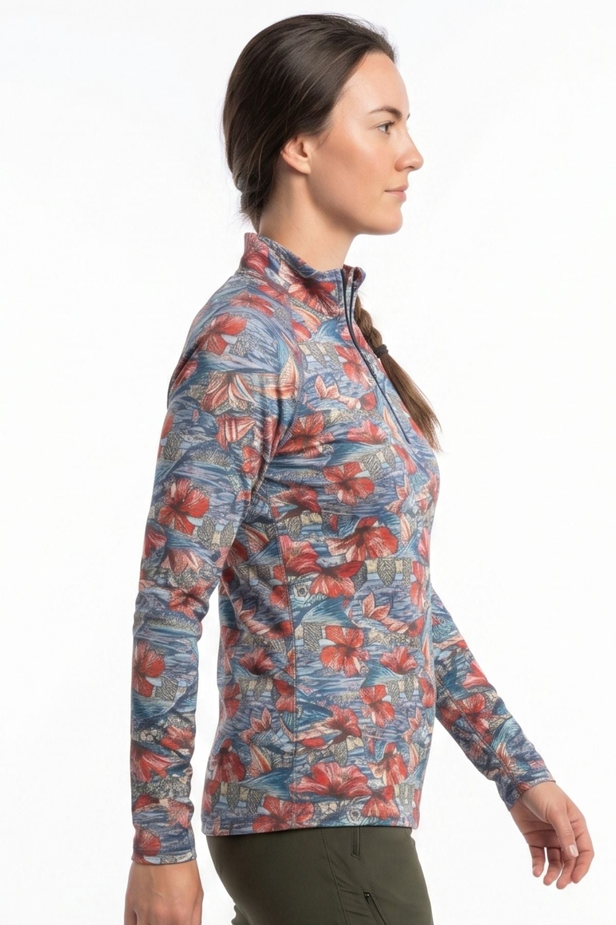 Woman wearing a colorful floral patterned long-sleeve shirt on a white background
