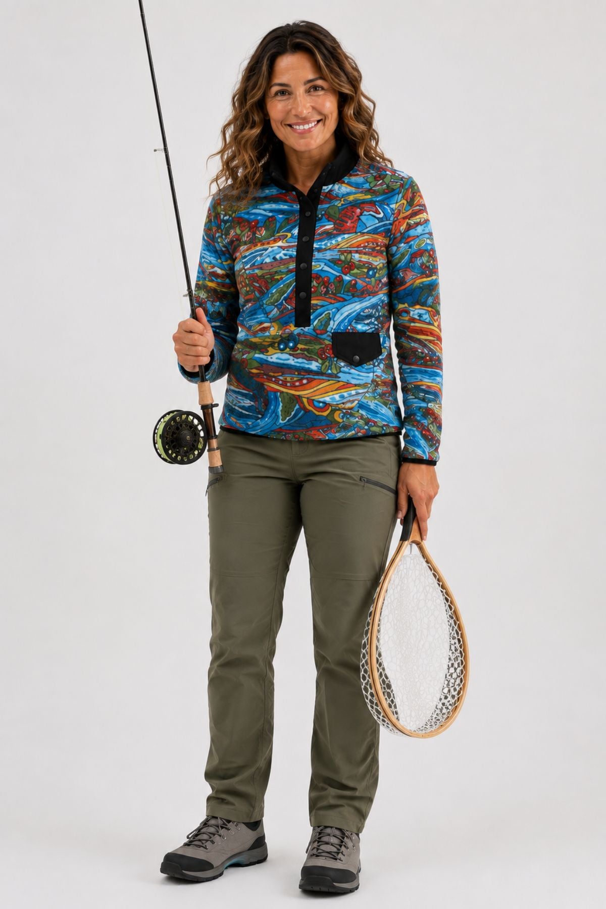 Waist-up studio hero image of a woman wearing the Charvana Riffle Snap Fleece, showing the full front design.