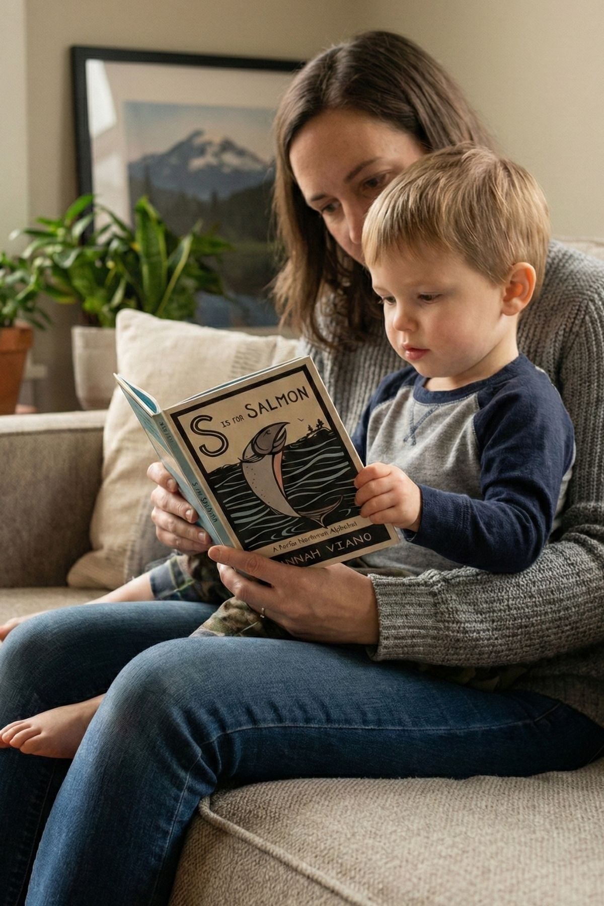 Woman reading a book to a child on a couch