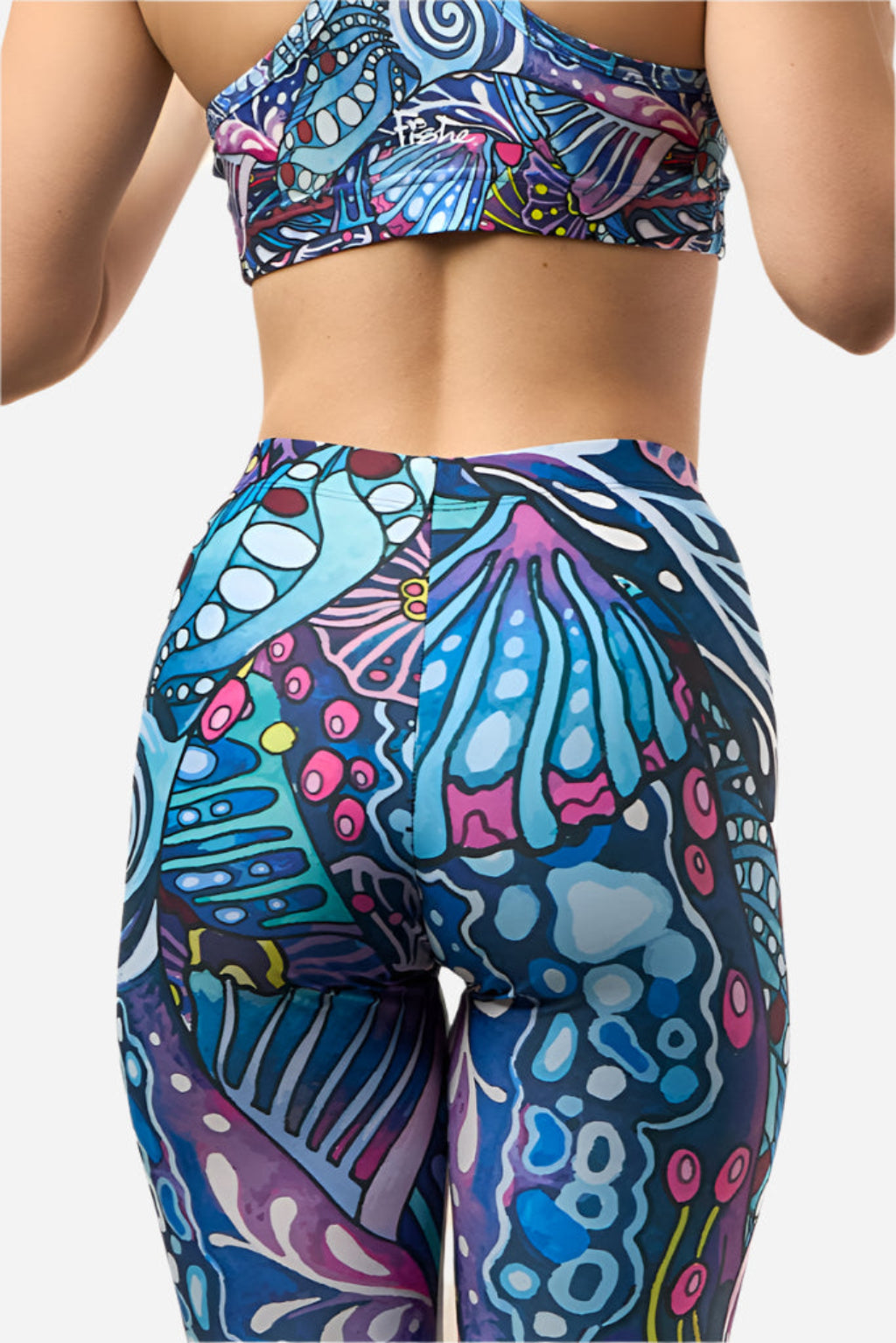 Colorful patterned top and leggings set on a plain background