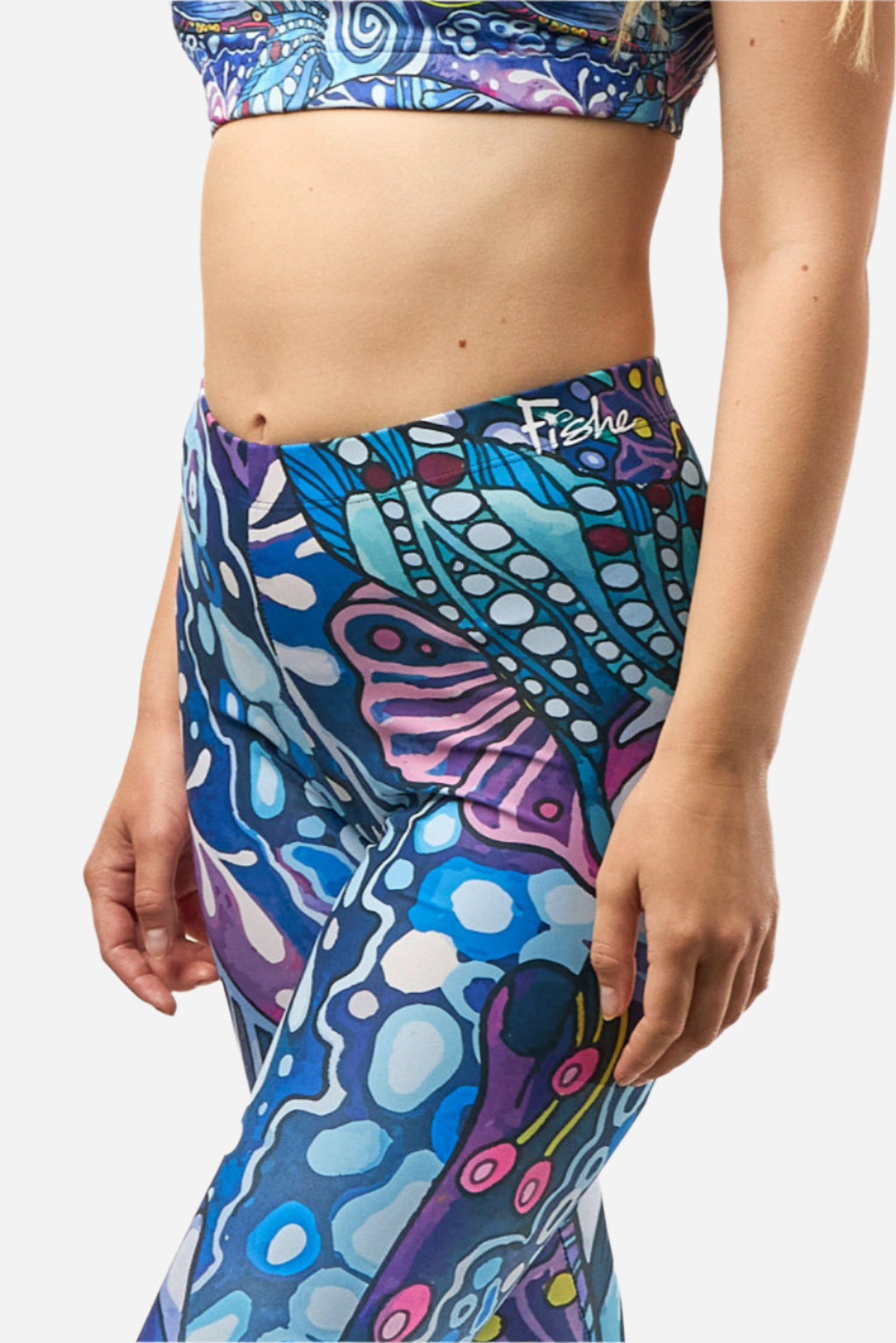 Colorful patterned leggings with a visible brand logo on a plain background