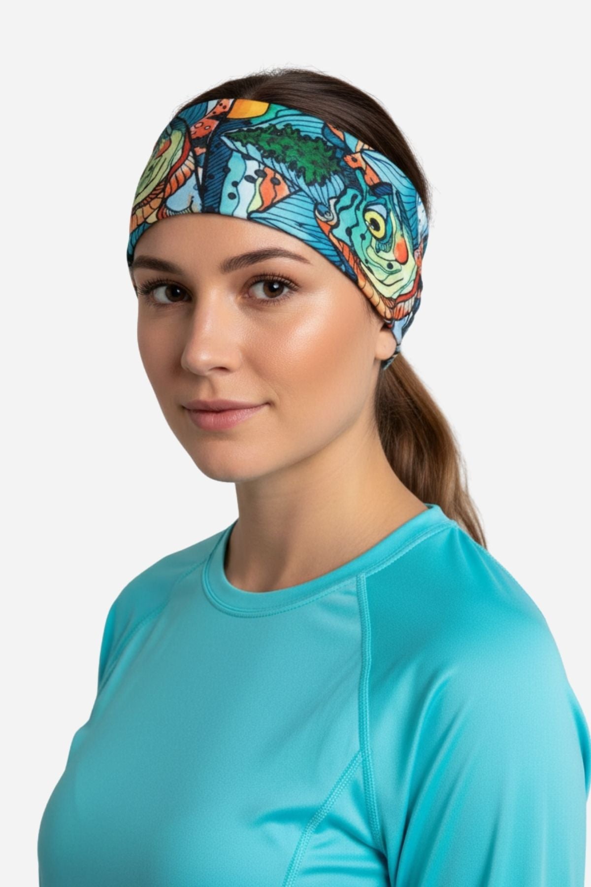 Woman wearing a colorful headband and turquoise shirt on a white background