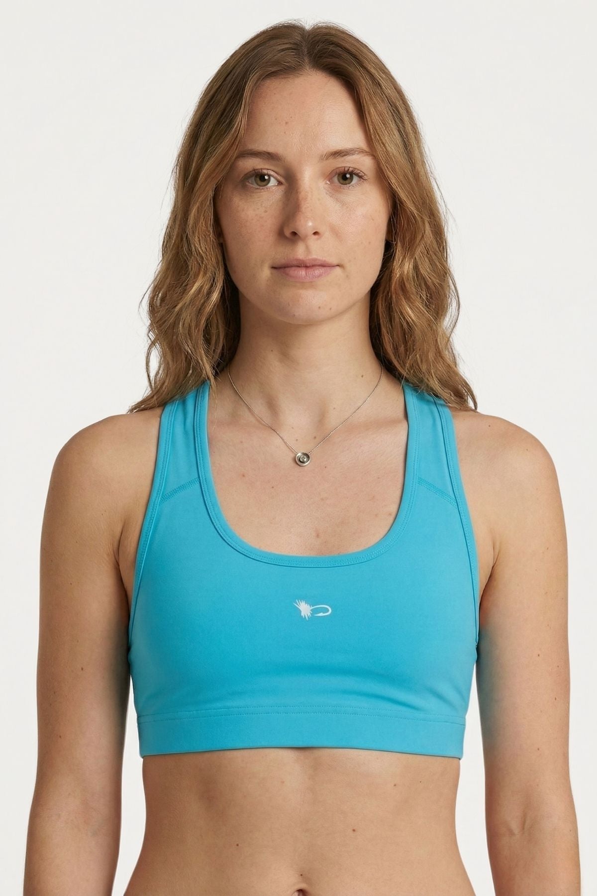 Woman wearing a blue sports bra on a white background