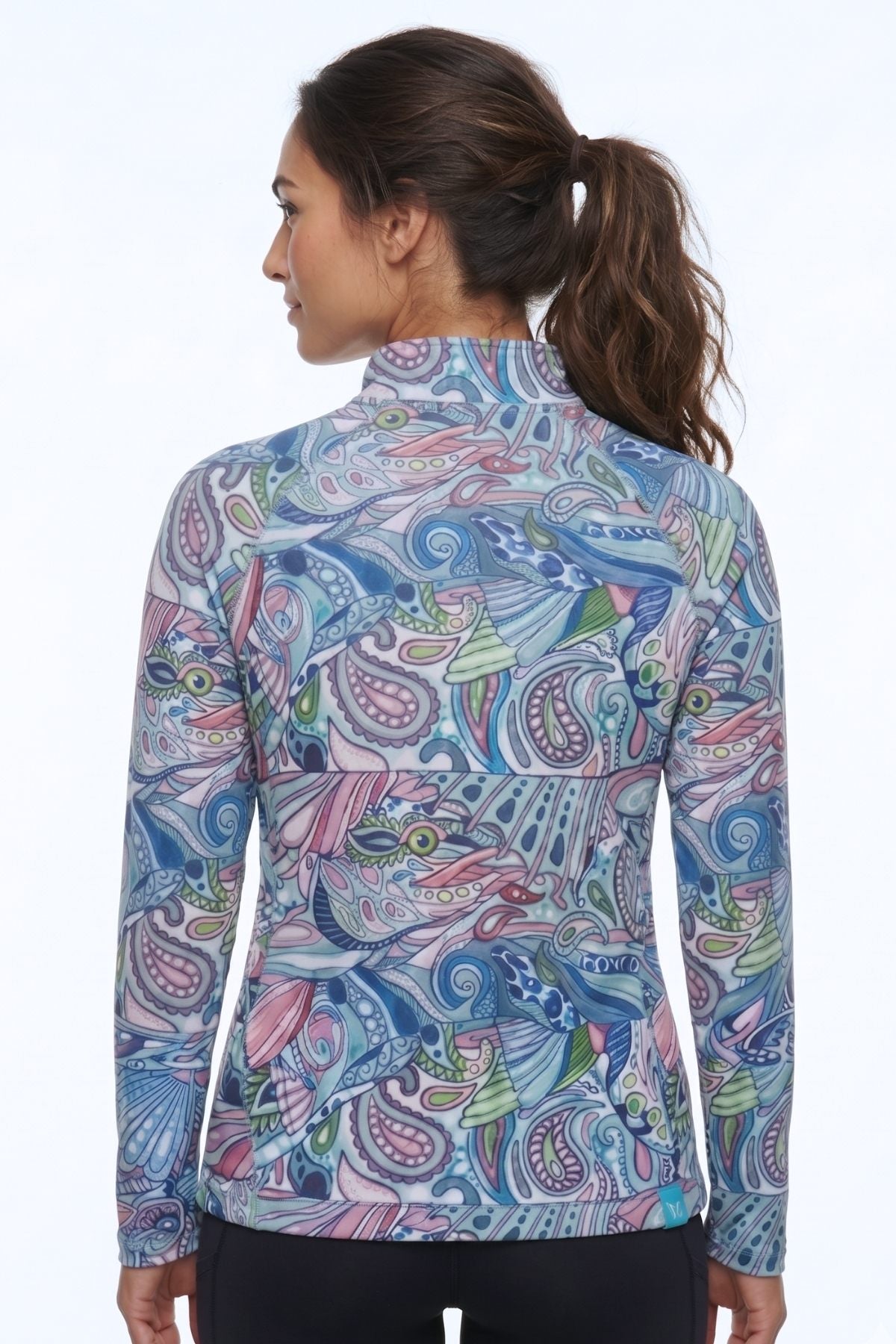 Woman wearing a colorful paisley patterned jacket on a white background