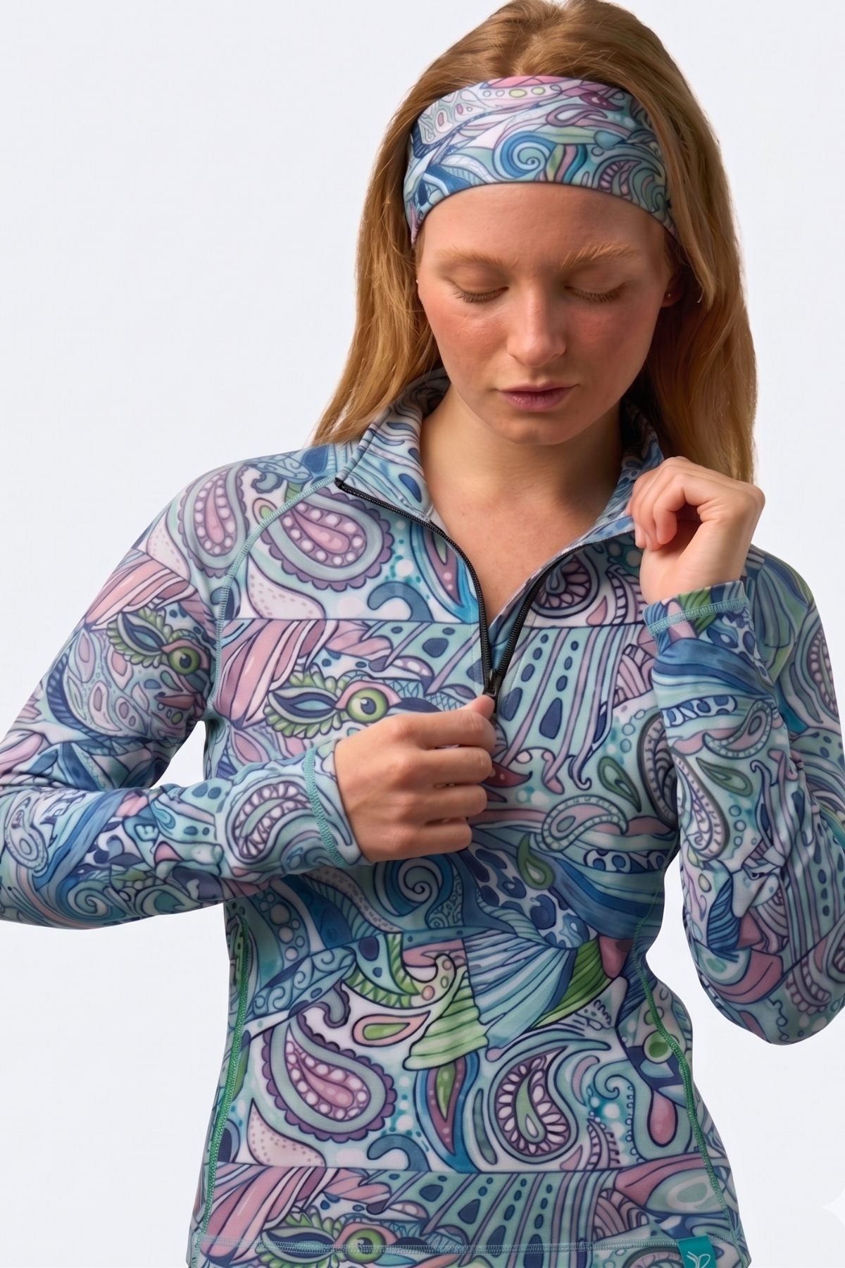 Woman wearing a colorful patterned shirt and headband on a white background