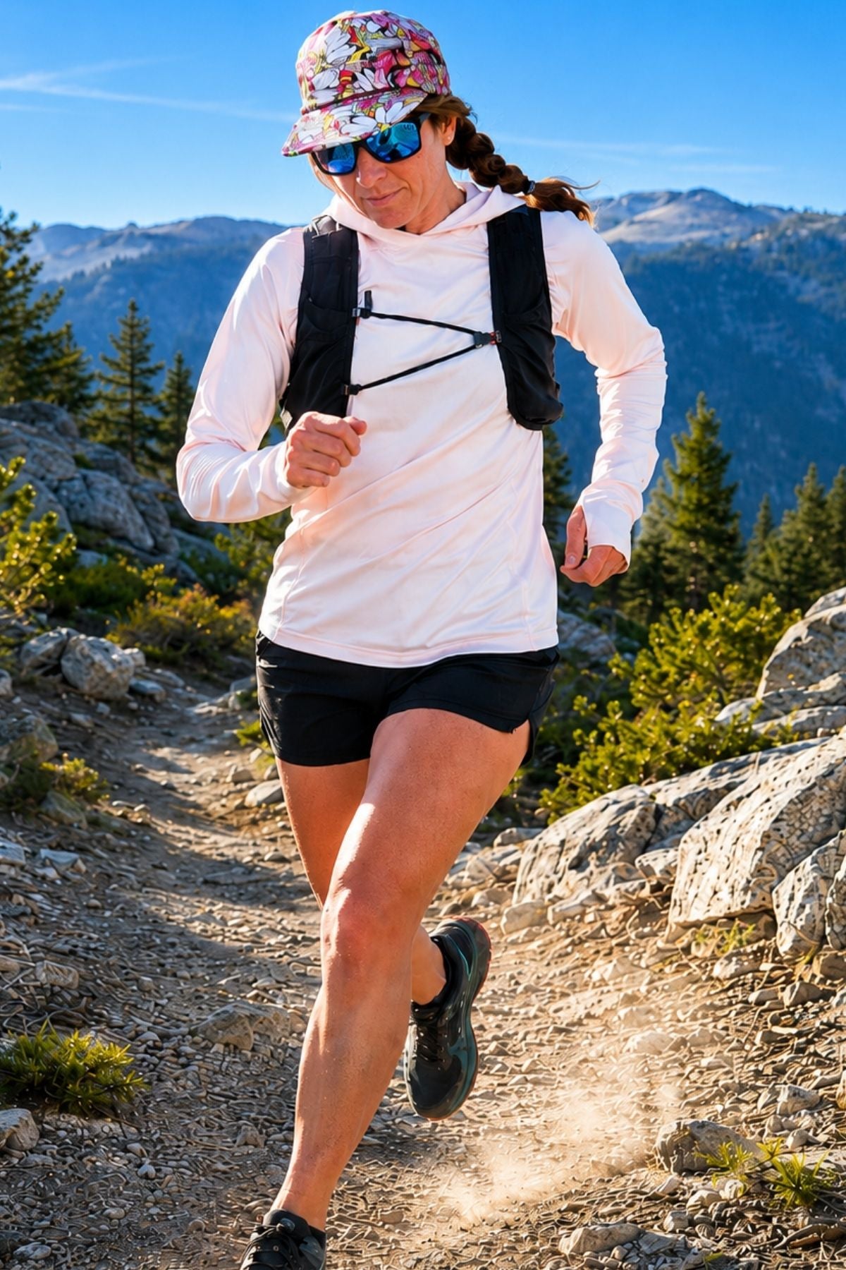 Person running on a mountain trail with backpack and sunglasses