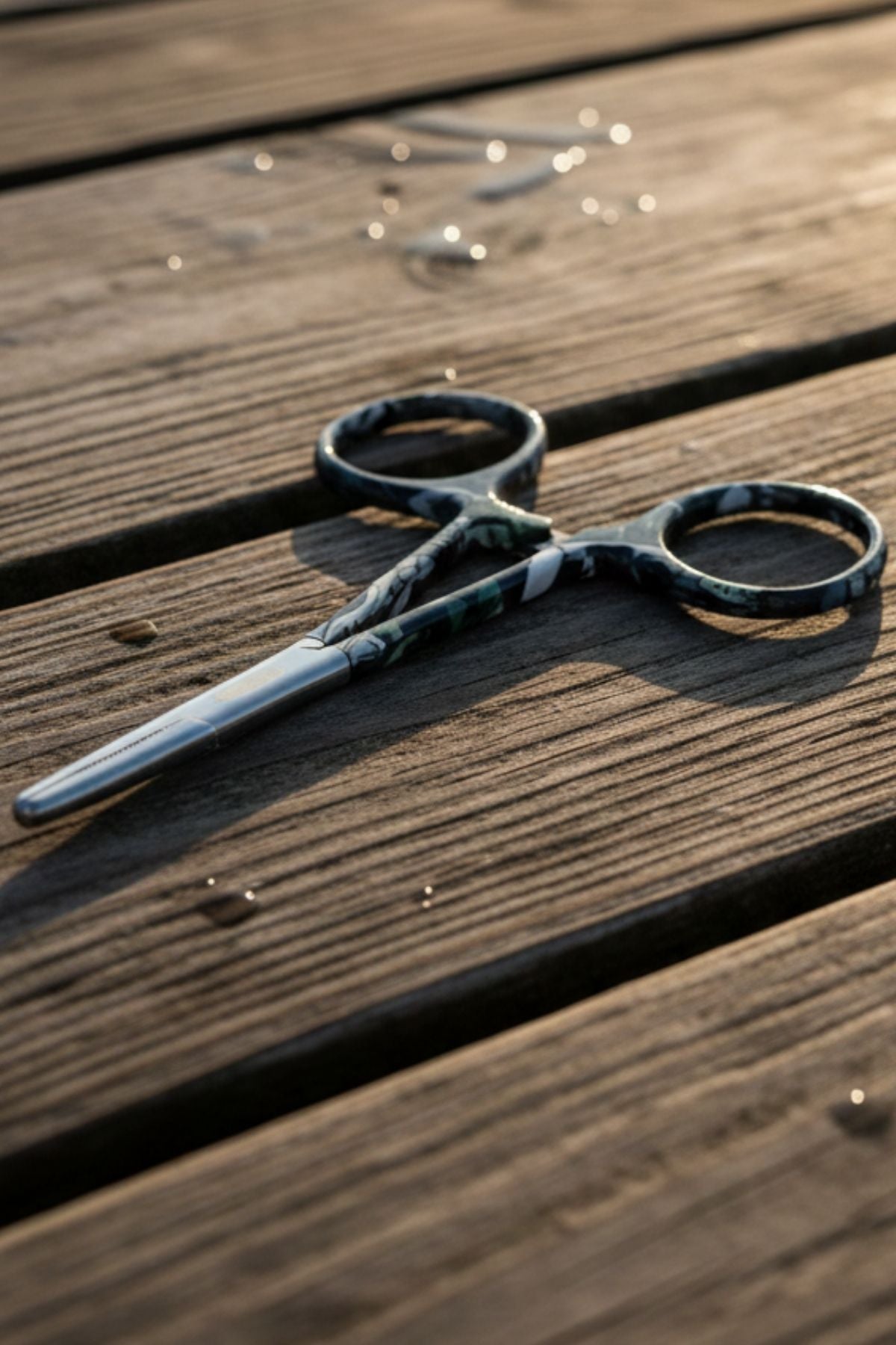 Pair of scissors on a wooden surface