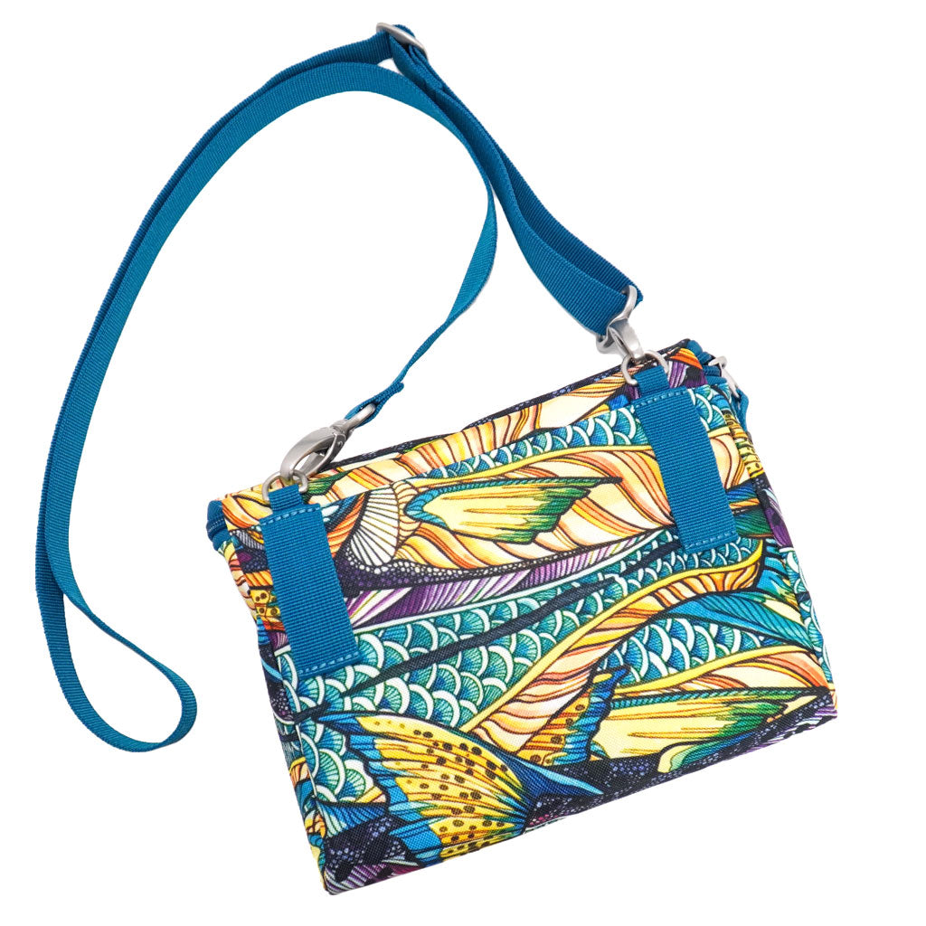 A crossbody bag with Fishe Kaliedo King pattern, two zipped sections, a shoulder strap and a fish patch on the front.