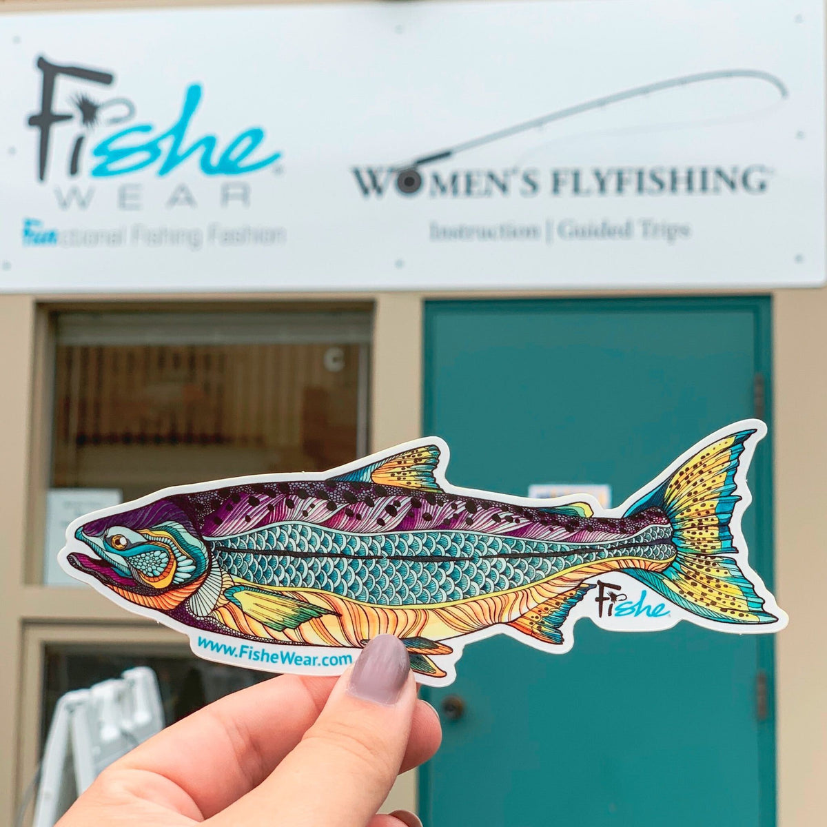 Kaleido King fish sticker held outside the FisheWear store
