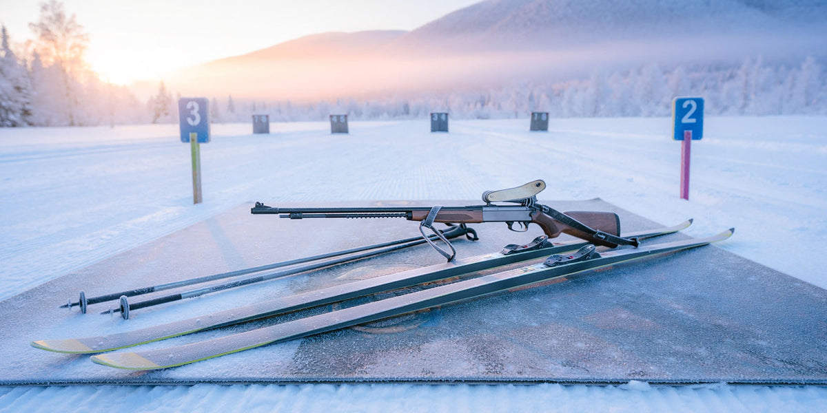 Cross-country skis and biathlon equipment at a snowy winter shooting range