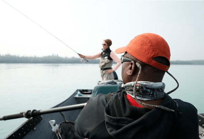 Angler wearing polarized fishing sunglasses beside reflective water