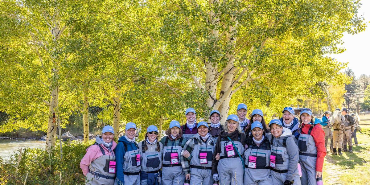 Women learning and practicing fly casting together outdoors