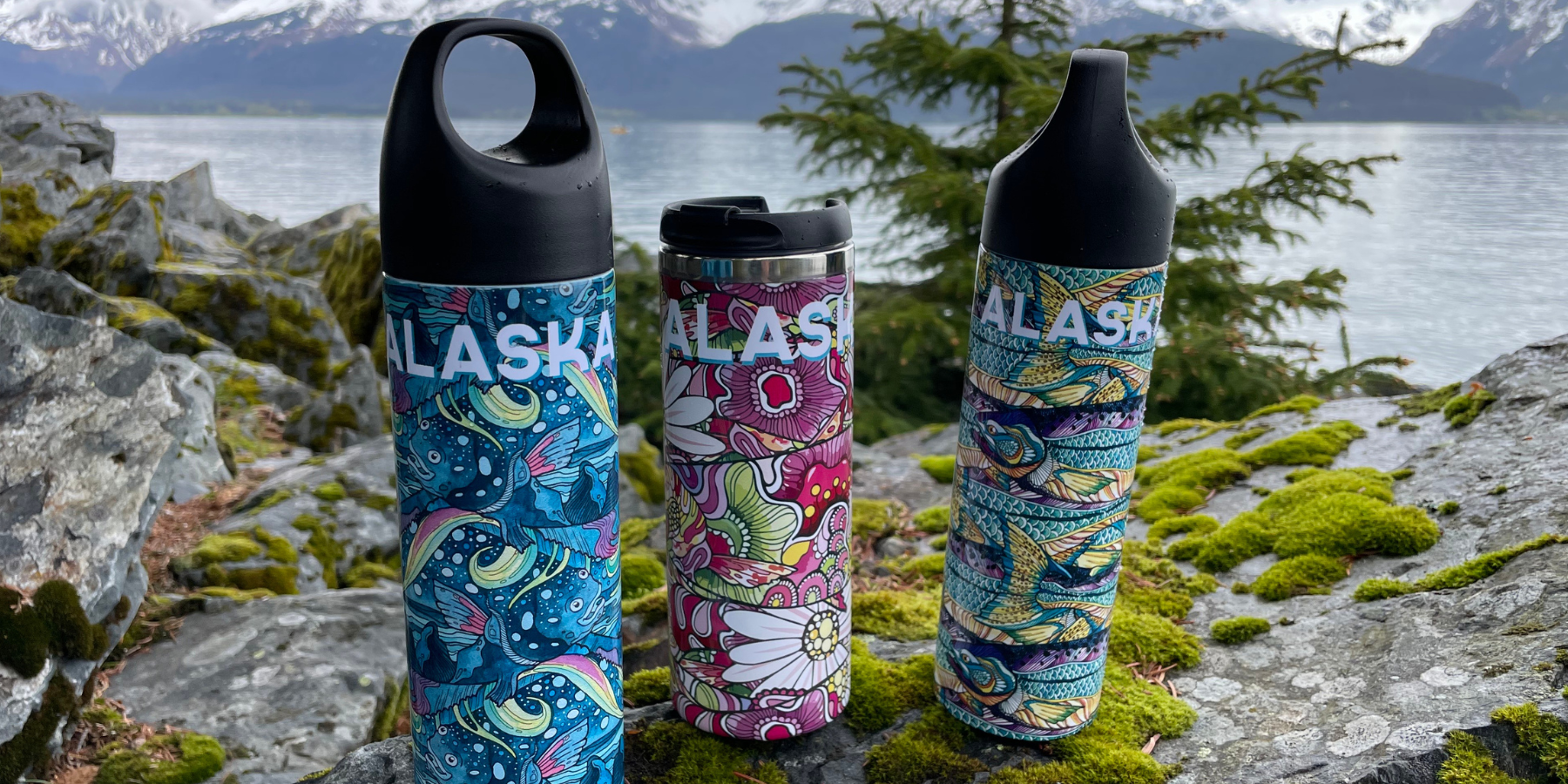 water bottle and thermoses with the alaskan landscape behind.