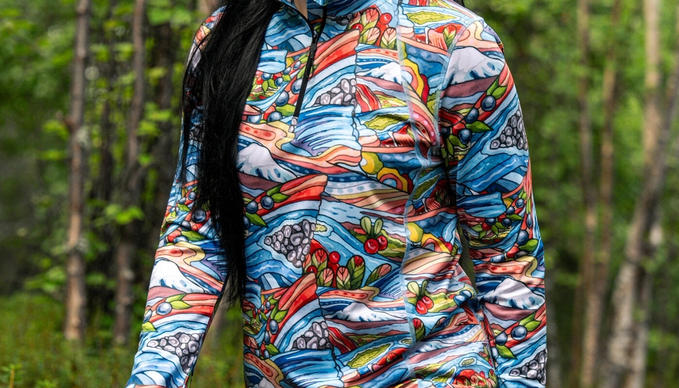 Person wearing a colorful patterned jacket in a forest setting