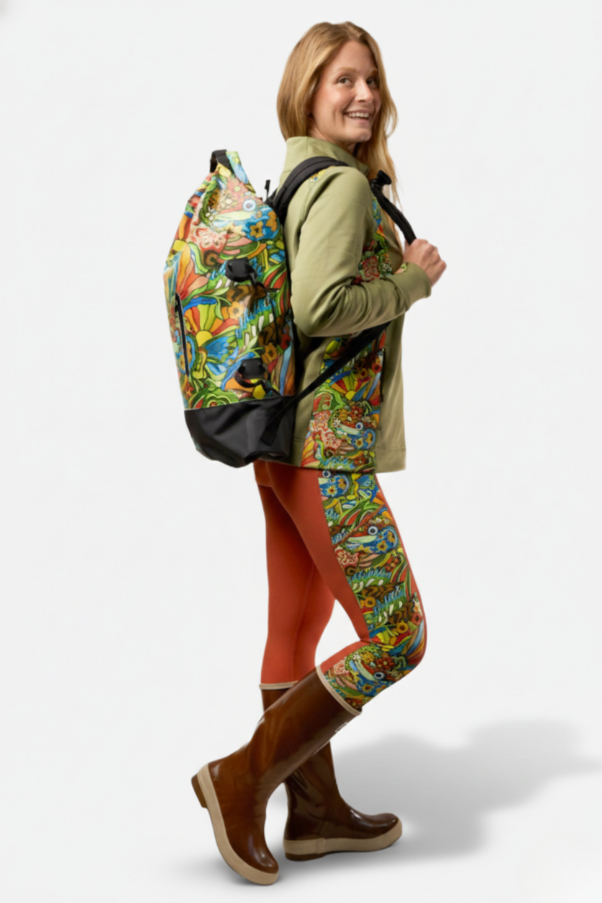 Woman wearing a colorful backpack and leggings on a white background