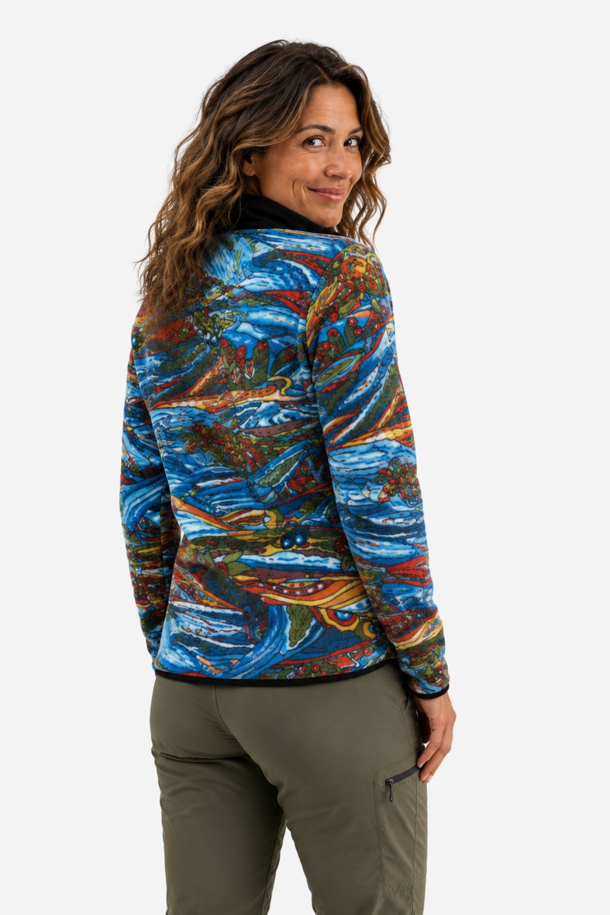 Woman modeling the back of the Charvana Riffle Snap Fleece while looking over her shoulder in studio.