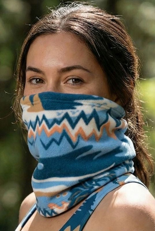 Woman wearing a blue patterned neck gaiter outdoors