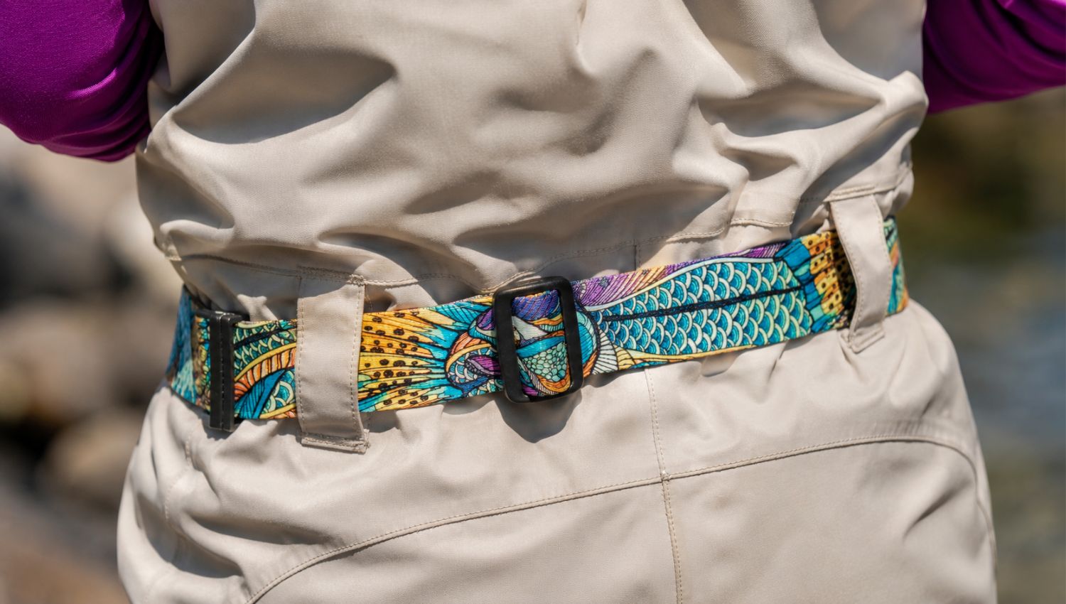 Colorful belt with a pattern worn on beige pants against a blurred natural background