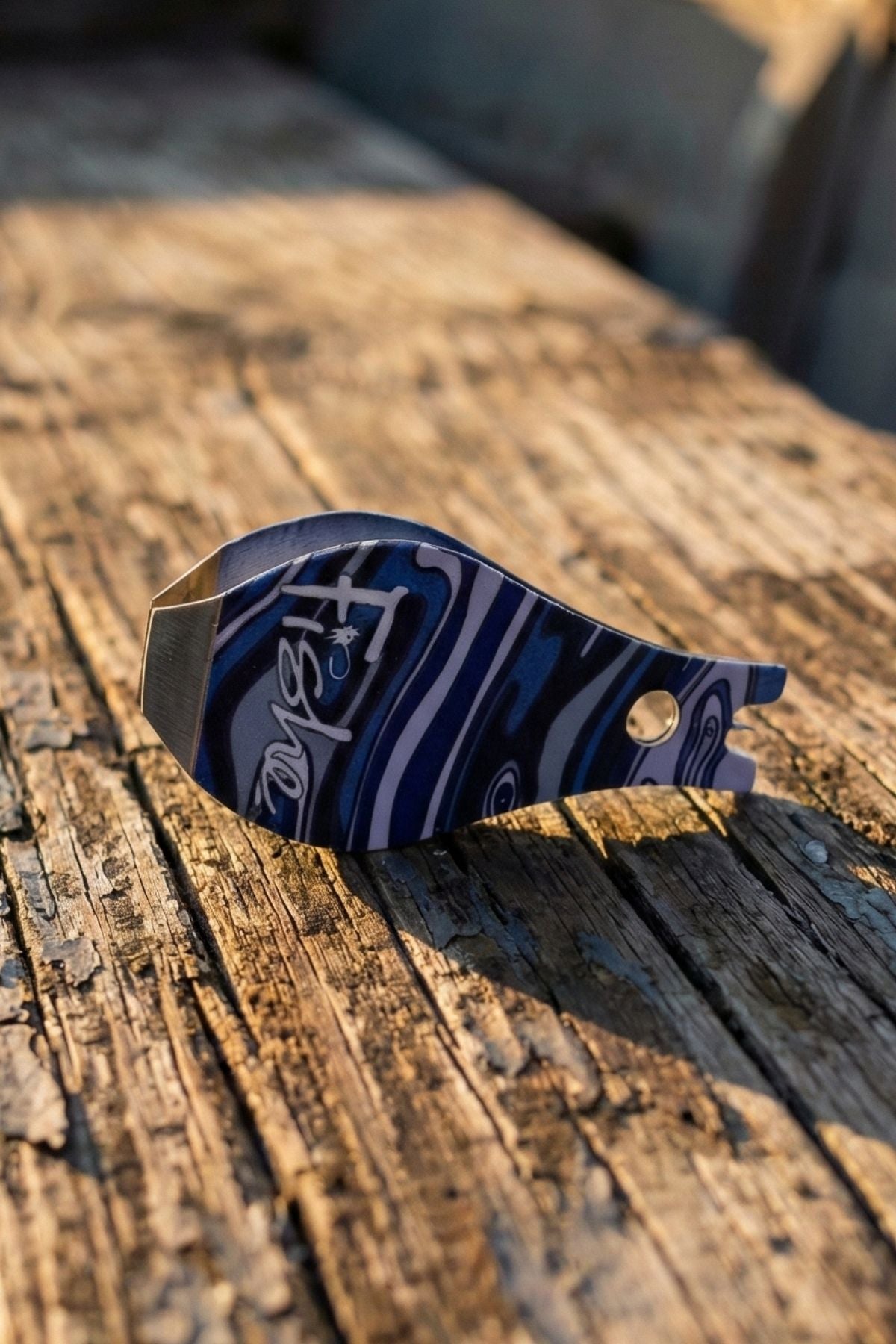 Blue and silver handguard on a wooden surface