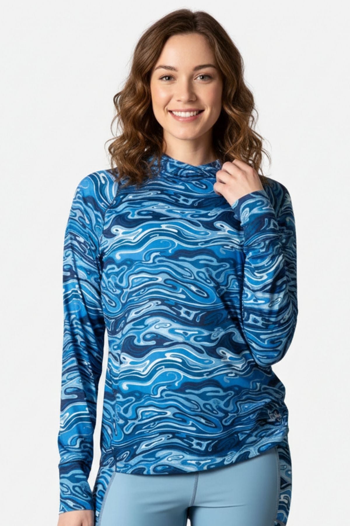 Woman wearing a blue patterned long-sleeve shirt on a white background