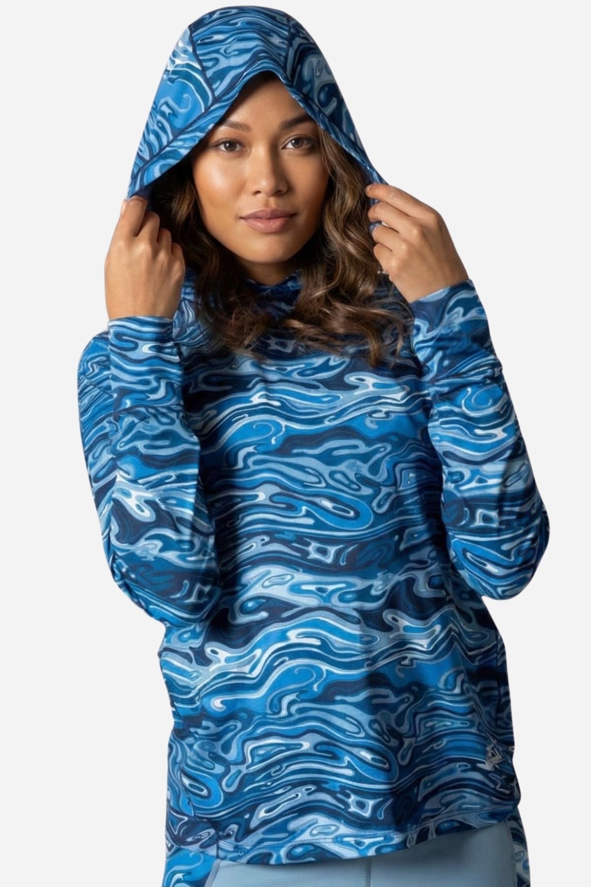 Woman wearing a blue patterned hoodie against a white background