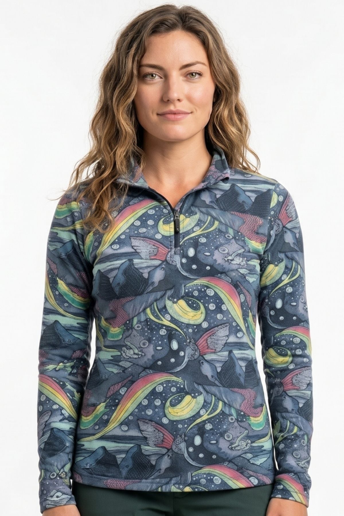 Woman wearing a colorful patterned long-sleeve shirt against a white background