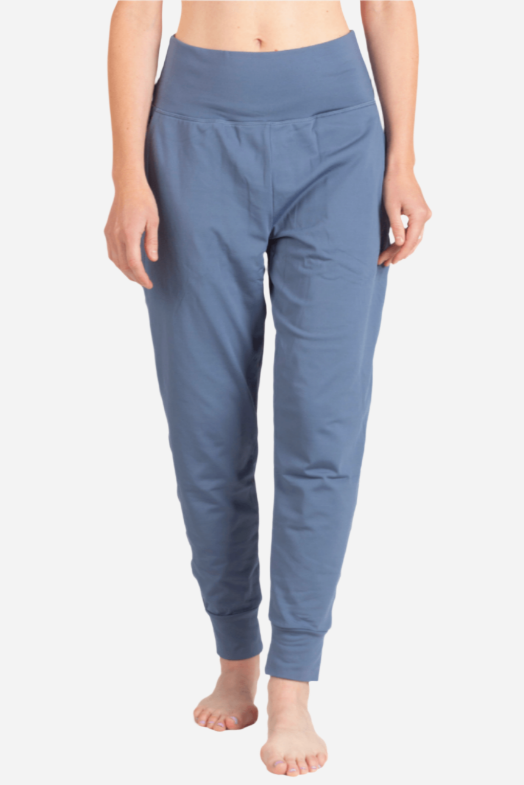 Blue jogger pants worn by a person on a white background
