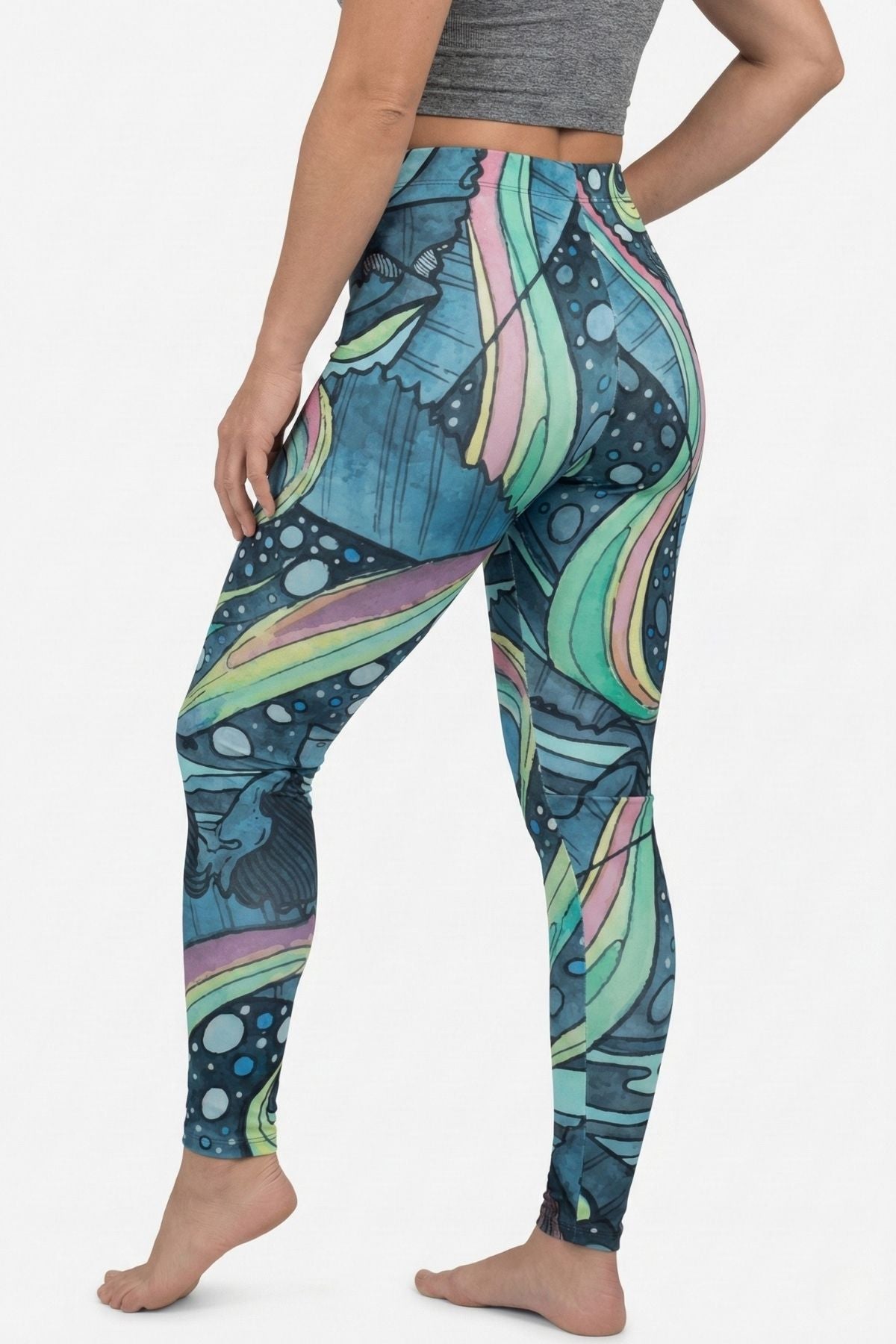 Person wearing colorful patterned leggings on a white background