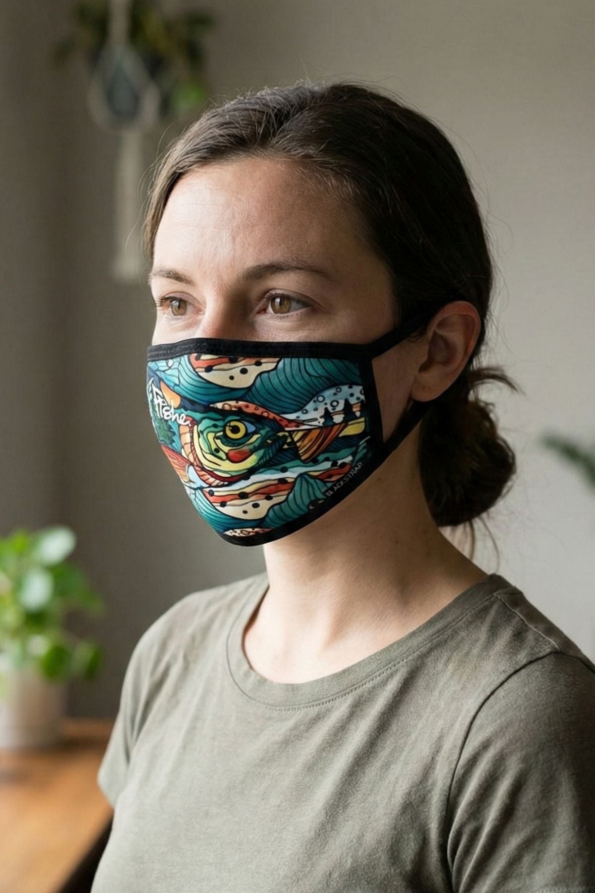 Person wearing a colorful face mask with a neutral background