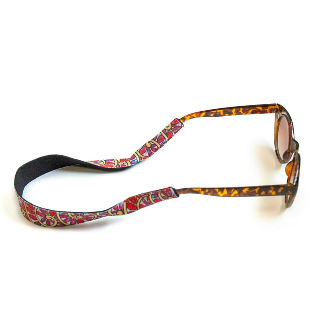 The Troutrageous Rainbow Eyewear Retainer connected to a pair of sunglasses.